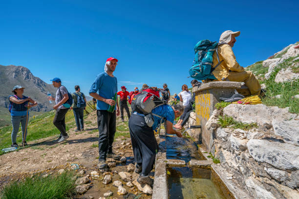 the kartal mountain and  Saklı Summit in Antalya Konyaaltı, Antalya, Turkey-May 19, 2021: people are enjoying the cold and fresh water spring and the summit of the kartal mountain and  Saklı Summit in Antalya kartal stock pictures, royalty-free photos & images