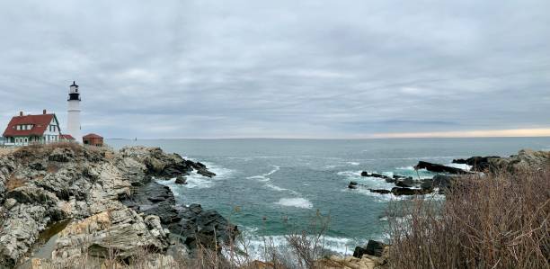 The Lighthouse A lighthouse on the beach in Winter Island Park at Waikiki Beach in Salem, MA - March, 2019 salem massachusetts stock pictures, royalty-free photos & images