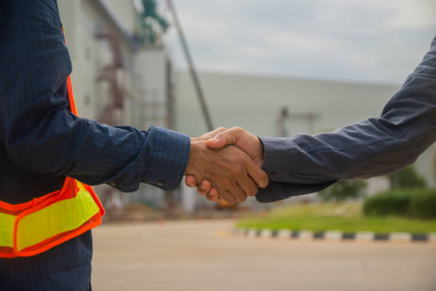 istock Businessman two people shake hand success at construction site partnership community 1320344758