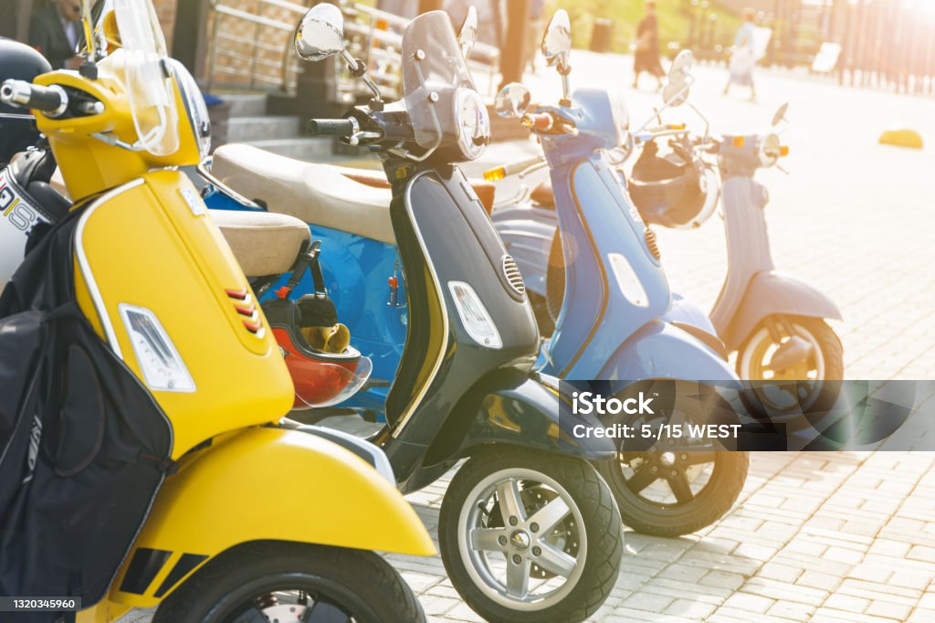 Multicolored mopeds in the parking lot in the city Motorcycle Stock Photo