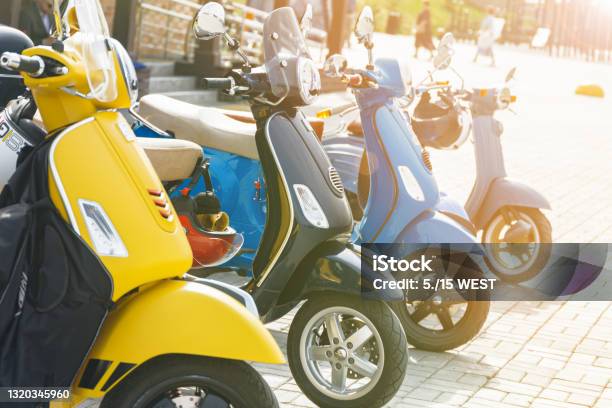 Multicolored Mopeds In The Parking Lot In The City Stock Photo - Download Image Now - Motorcycle, Moped, Electricity
