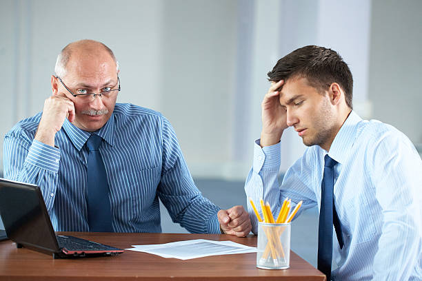 istock two tired overworked businessman gets some rest, office shoot 132034740