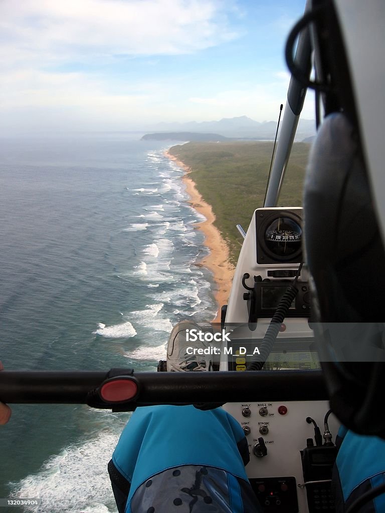 Coastal adventure Aerial view of a coastline taken from the open air cockpit of a microlight, cockpit visible. Adventure Stock Photo