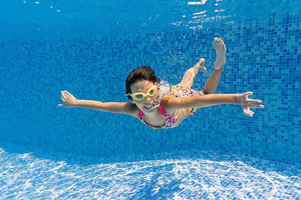 istock Happy smiling underwater child in swimming pool 132034921