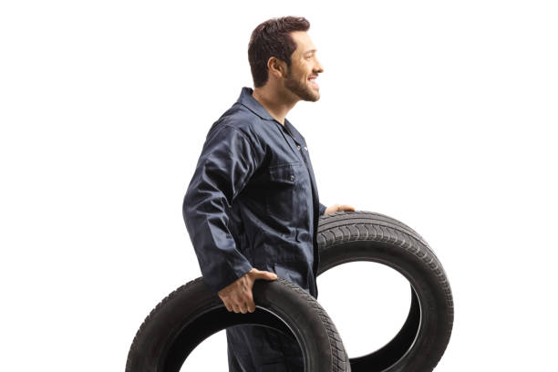 istock Aauto mechanic worker carrying big tires 1320349701