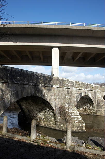 istock Old stone river bridge and motorway flyover 132035074