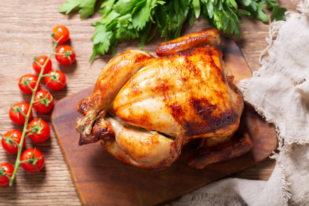 istock whole roasted chicken on a wooden board, top view 1320351189