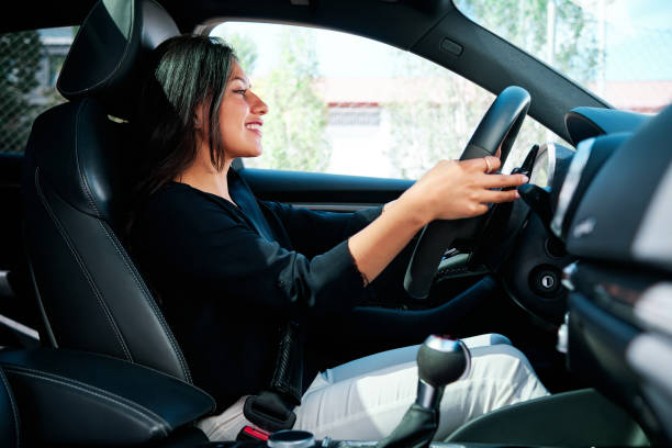 istock young latin woman driving luxury car 1320352065