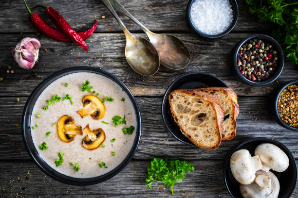 istock Cream white mushroom soup on wooden table 1320354835