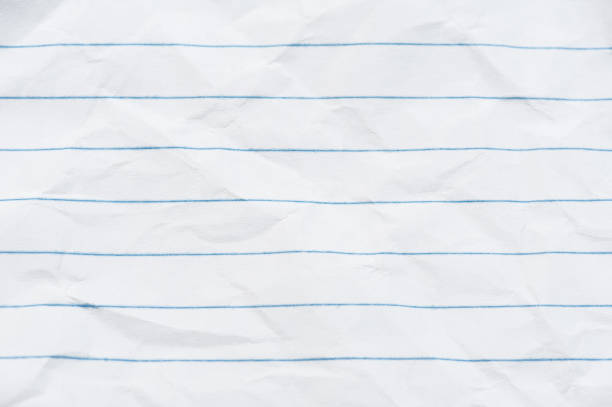 istock Crumpled sheet of white paper in a ruler. Background 1320354890