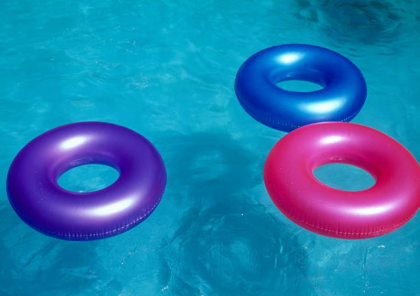 istock Colorful tubes floating in te pool 1320356211