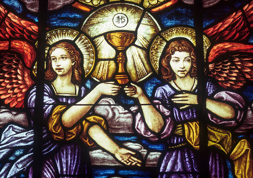 Stained glass of angels holding cup