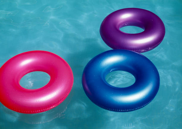 istock Colorful tubes floating in te pool 1320356300