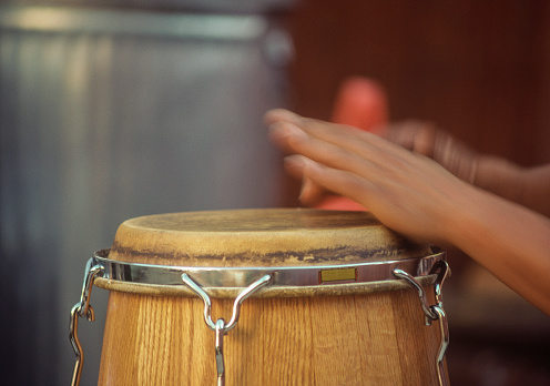 Man's hand playing conga drums, Close-up