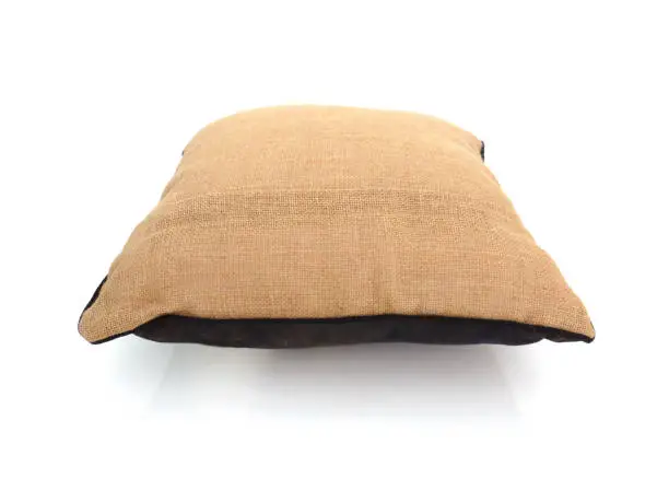 Perspective view of square natural fiber cushion in white background. Close up of handmade jute and brown cotton cushion. Luxury brown beige square pillow isolated. Houseware and Home Accessories.