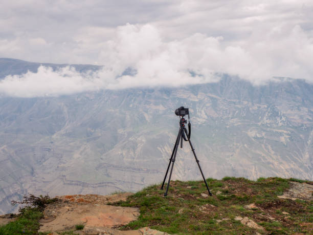 istock Tripod with a camera over a cliff. Performing a long exposure. 1320357249