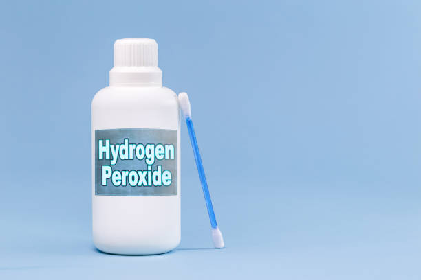 istock plastic container, medicine bottle, written in english: hydrogen peroxide, isolated blue background, concept of first care 1320358424