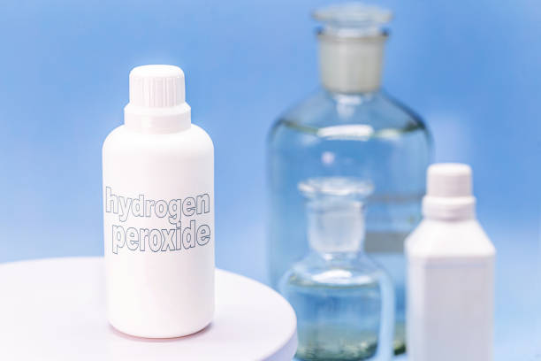 plastic container, medicine bottle, written in english: hydrogen peroxide, isolated blue background, concept of first care plastic container, medicine bottle, written in english: hydrogen peroxide, isolated blue background, concept of first care glass medicine blue bottle stock pictures, royalty-free photos & images