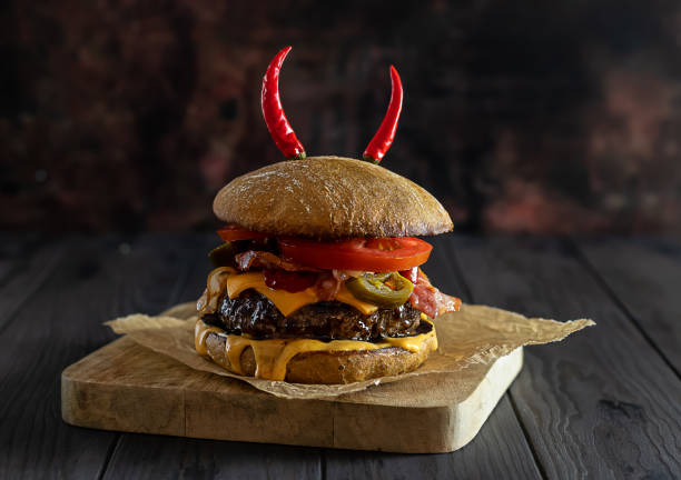 istock Delicious craft beef burger with jalapenos, cheese, bacon, and whole wheat bun. 1320359395