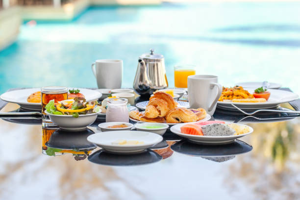 istock American Breakfast Set on Table Next to Poolside in Resort 1320360314