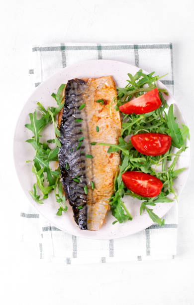istock Roasted mackerel with arugula and tomatoes 1320361565
