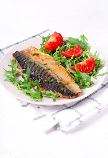 istock Roasted mackerel with arugula and tomatoes 1320361566