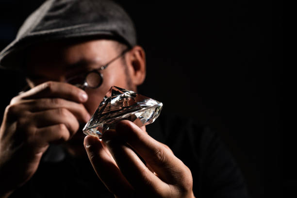 A diamond is polished by a skilled worker in the diamond processing
