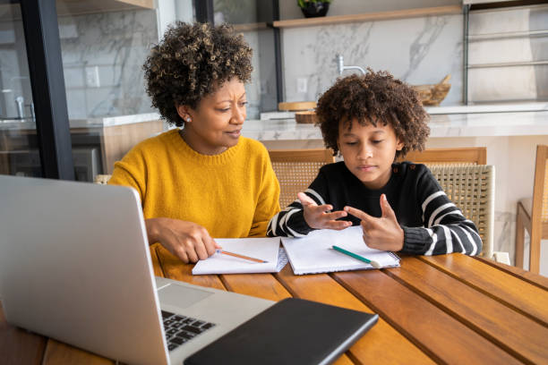 istock African american mom helping son to study online. Homeschooling education during quarantine. 1320362592