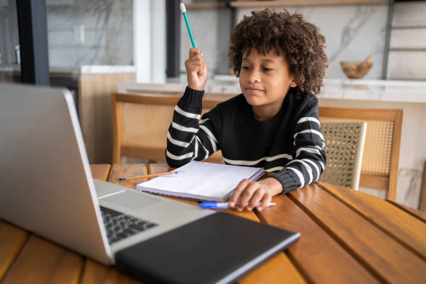 istock African american kid learn online. Homeschooling education during quarantine. 1320362594