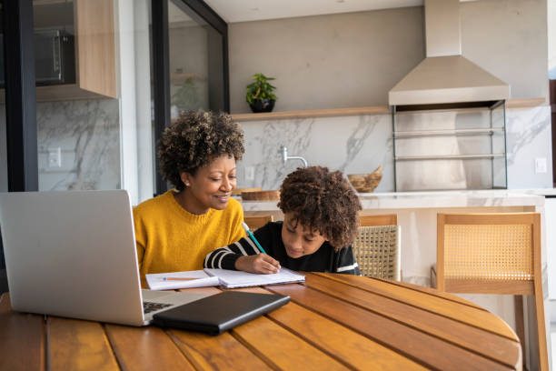 istock African american mom helping son to study online. Homeschooling education during quarantine. 1320362615