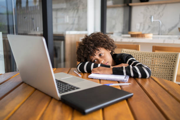 istock African american bored kid learn online. Homeschooling education during quarantine. 1320362617