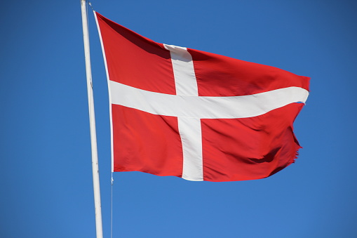 May 31, 2015, Lökken: The Danish flag flutters in front of a blue sky in the wind