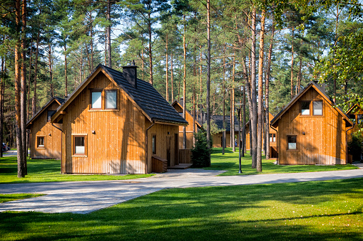 Borsk, Poland - September 01,2019:Wooden, holiday cottages in the woods by the lake Wdzydze in Kashubia land