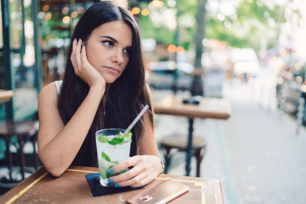 istock Dreamy woman drinking mojito 1320371779
