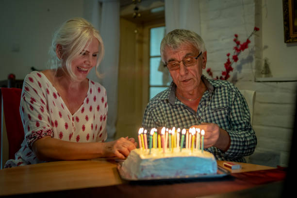 istock Senior couple blowing out candles 1320372026