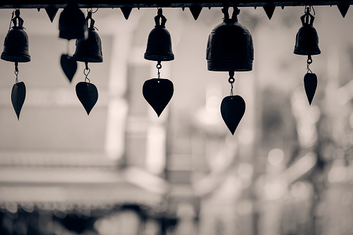 Tradition asian bells hanging , golden buddha background.