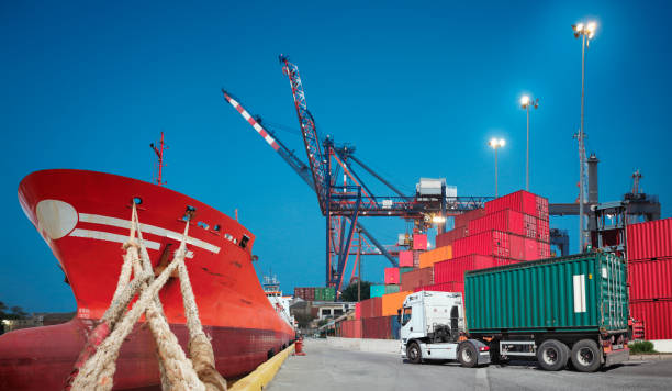 istock Cargo ship, freight truck and containers in the port 1320372924