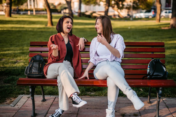 istock Two women chatting on park bench 1320377480