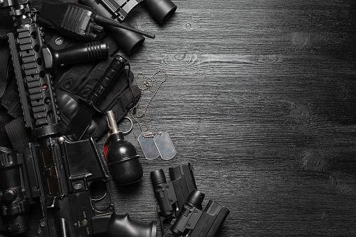 Airsoft equipment on the black flat lay background with copy space.
