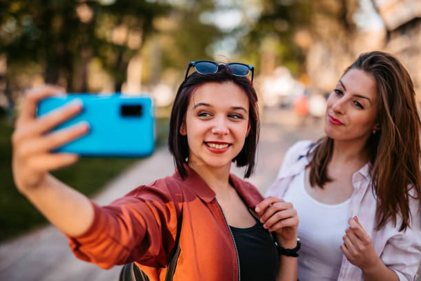 istock Smiling women making selfie together 1320379427