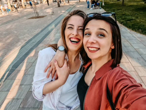 istock Smiling women making selfie together 1320379457