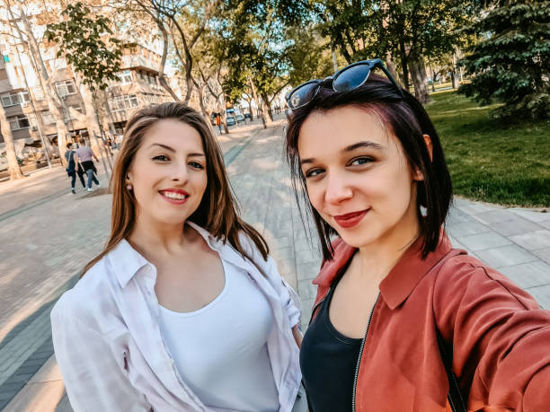 istock Smiling women making selfie together 1320379477