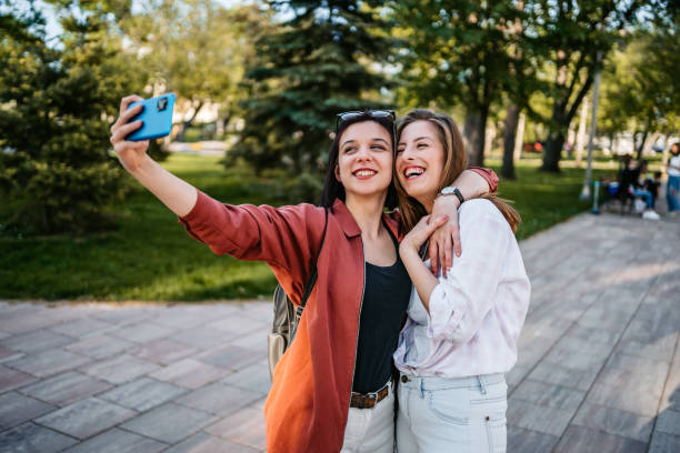 istock Smiling women making selfie together 1320379537