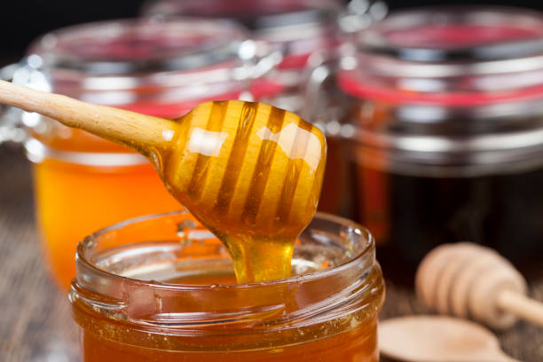 istock a spoon for honey together with high-quality bee honey 1320380969
