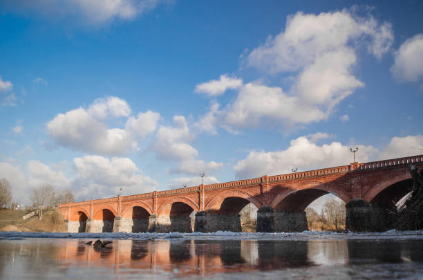 istock Long brick bridge over Venta river in winter day, Kuldiga, Latvia 1320382244