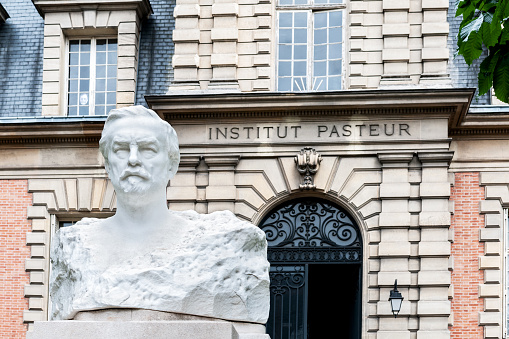 The Pasteur Institute (Institut Pasteur) is a French non-profit private foundation dedicated to the study of biology, micro-organisms, diseases, and vaccines. It is named after Louis Pasteur, who made some of the greatest breakthroughs in modern medicine at the time, including pasteurization and vaccines for anthrax and rabies. The institute was founded in 1887. For over a century, the Institut Pasteur has been at the forefront of the battle against infectious disease. Since 2020, the Pasteur Institute has been working on research into the vaccine against the Covid-19 coronavirus.  The sculpture of Pasteur is from Naoum Aronson, made in 1923 in Paris for the Pasteur Institute.  Paris 15 th district / arrondissement,  in France. September 29, 2020.