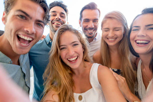 istock Group of friends taking a selfie laughing and smiling and pulling silly faces. 1320385224