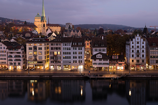 Aerial view of Zurich at dusk, river Limmat is seen in the foreground, Switzerland.