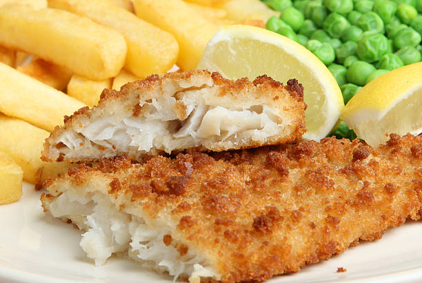 London UK, September 03 2025,  Breaded Cod Fillet With Sliced New Potatoes And Mushy Peas With No People