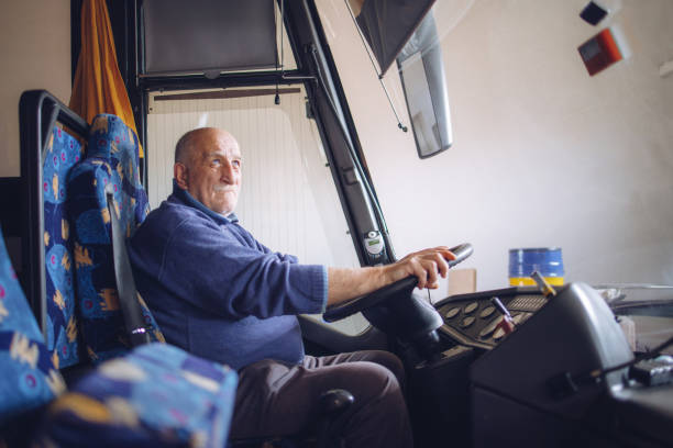 istock Senior male driver driving bus 1320388126
